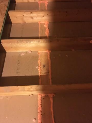 Spray foam insulation on wall plates before covering with cellulose