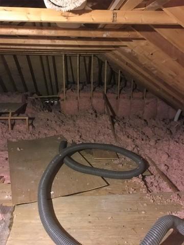 Old attic insulation before blown in cellulose