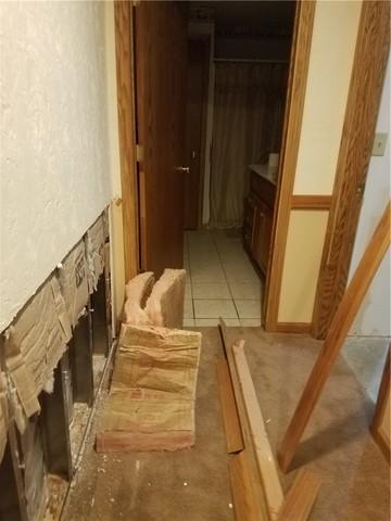 Water problems in finished basements can be tricky because the finishings hide water damage for quite a while. This section of wall was cut back and the floor was pulled up during the homeowner's DIY attempt and you can see staining on the floor indicative of water.