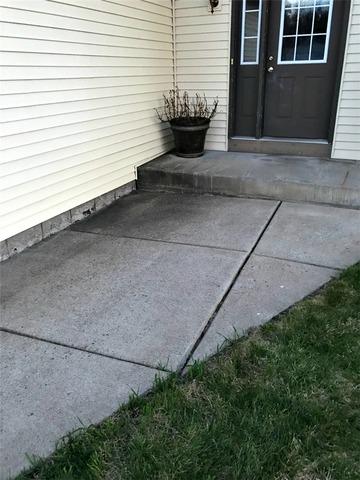 Residential sidewalk sinking in toward the foundation