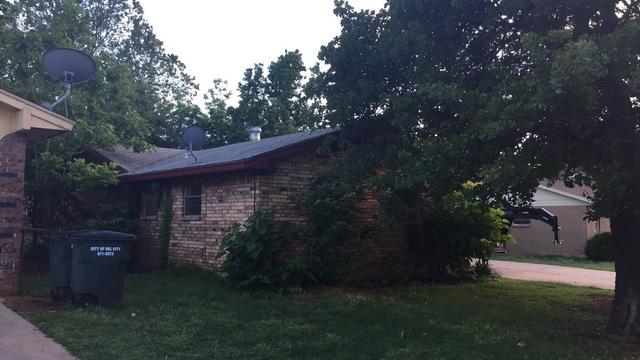 <p>Before working on the front of home with a green, damaged roof.</p>