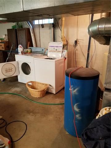 The staining on this basement floor is a major sign of water damage, as water comes up through the floor and leaves behind dissolved salts it picked up on the way through (efflourescence).