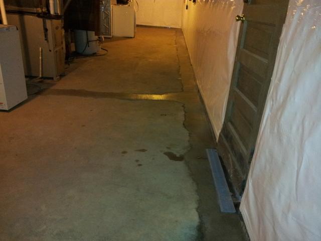 <p>We ran a trench drain in front of the walkout door that doesn't let moisture out, it only lets water in.</p>