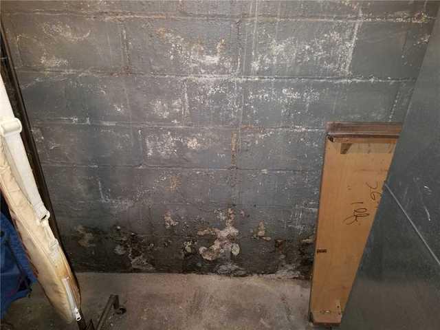 Heavy Water Damage Where Wall Meets Floor