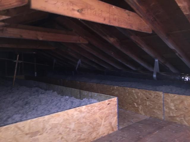 Flat is covered with cellulose which is separated from the storage deck by retaining dams. A catwalk extends to the end of the attic in order to keep any mechanicals or wiring accessible to the homeowner