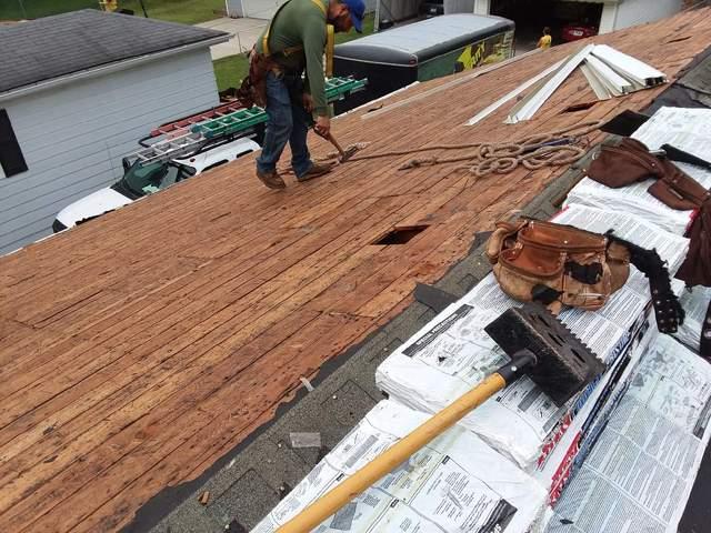 replacing the old shingles with new ones