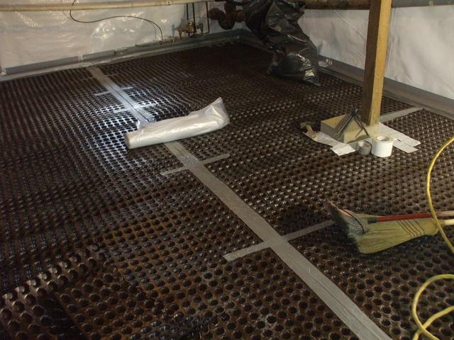 This picture shows drain matting installed on a basement floor