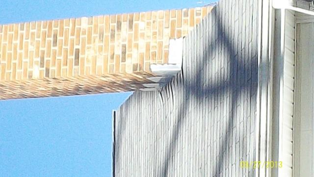 <p>The roof, installed before the lift, shows how much higher the house is now. The chimney is pushing the shingles back.</p>