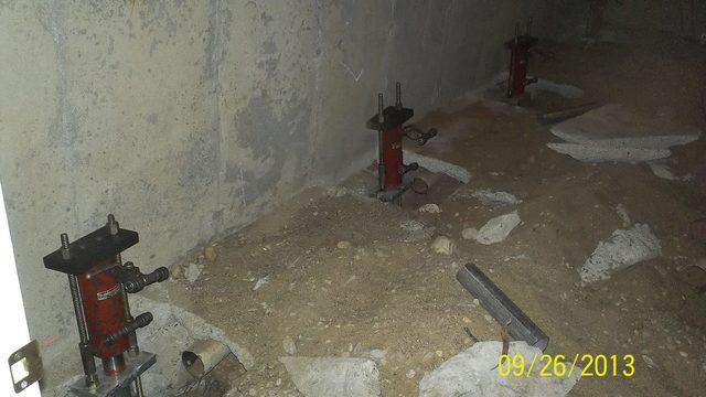 The lift cylinders, key aspects of the push piers, are being prepared in this picture.