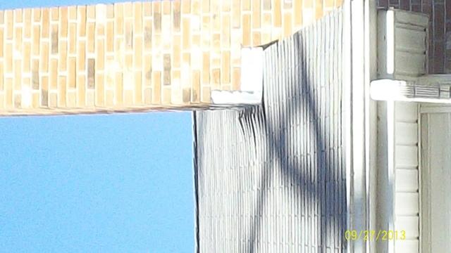 <p>The shingles on the roof of this house, which were installed before the lift, are being pushed back by the chimney because the house is so much higher.</p>