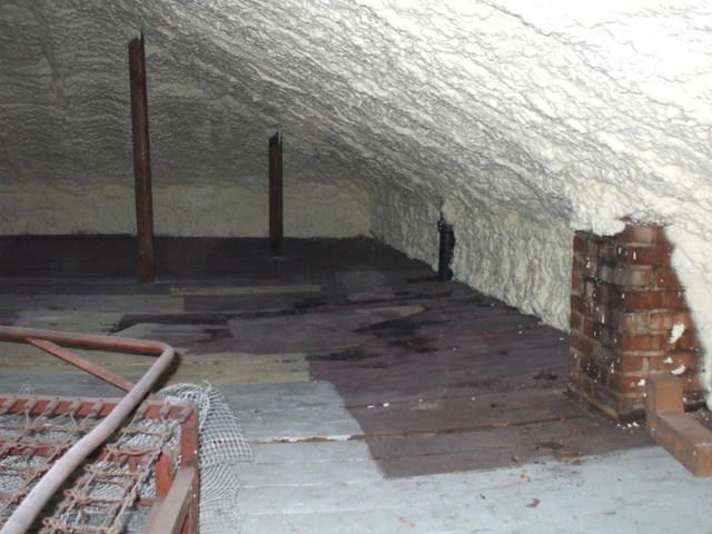 This photo shows an attic ceiling insulated with spray foam.