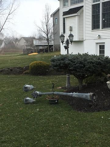 Three different light posts blown over in the back of customers home.