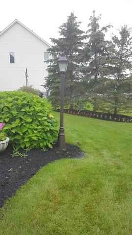 A new LED, energy efficient light replaces the three light lamp post that were blown over by a wind storm in the Penfield area.