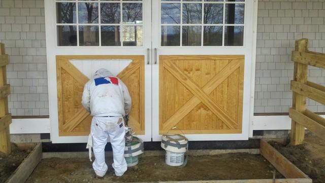 Barn Doors Being Stained