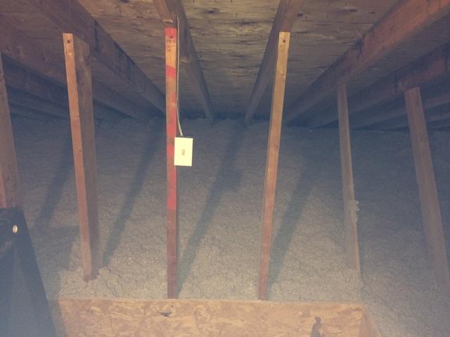 Cellulose now covers attic flat separated by retaining dams to keep storage deck clean.