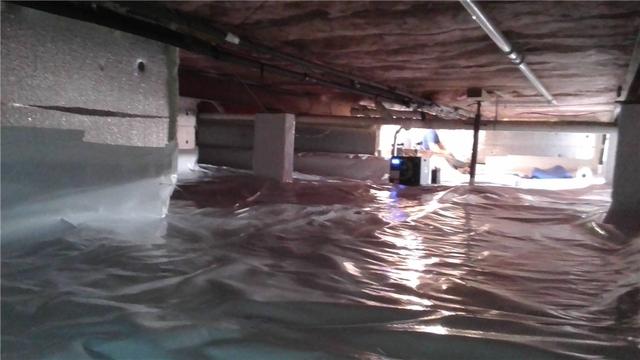 The finished crawl space is brighter, cleaner, and dryer. The SaniDry Sedona dehumidifier in the background helps to keep the humidity at safe levels and deposits any moisture that it removes in the sump system.