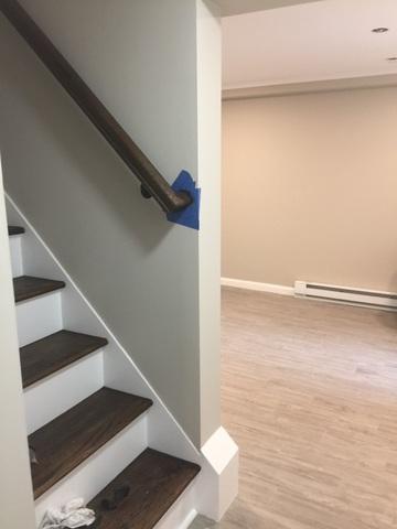 We installed new stairs with a hand railing. This is the oak tread style, which really gives this basement an elegant look