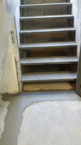 A TrenchDrain was installed by the stairs. Our Trench Drain effectively captures surface water at stairways, doorways, and along other openings.