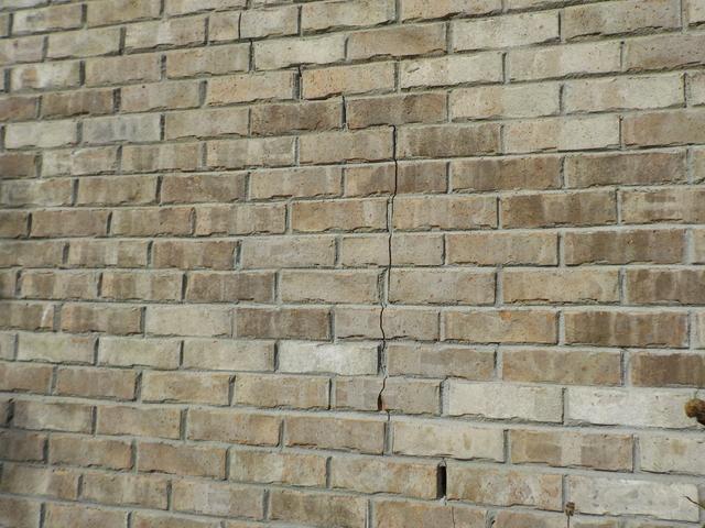 The exterior brick shows signs of movement.