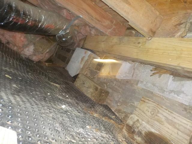 2"x8' joist were used to run alongside the rotten wood to carry the load. 
Delta drainage matting is laid down below the vapor barrier, the dimpled matting prevents ground water from being trapped and pooling under the thick plastic liner.