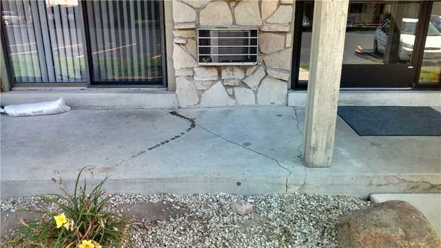 From water entering below the concrete slab and washing out the soil, the concrete slab supporting the second-floor balcony begins to sink and crack. If this problem is left unattained it can lead to further damage.