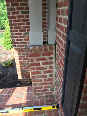 The way the porch sank caused a tilted separation from the home.