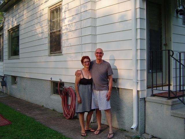 Happy homeowners with their freshly painted home