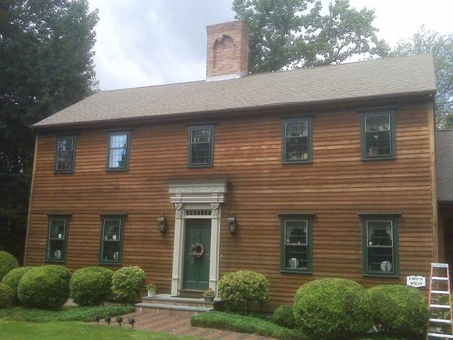 Stained house with painted trim, front view