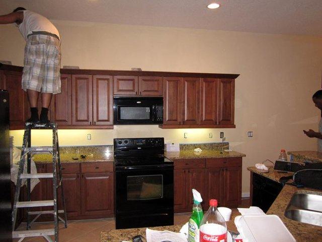 <p>Scholar workers paint carefully and efficiently around installed cabinets and appliances.</p>