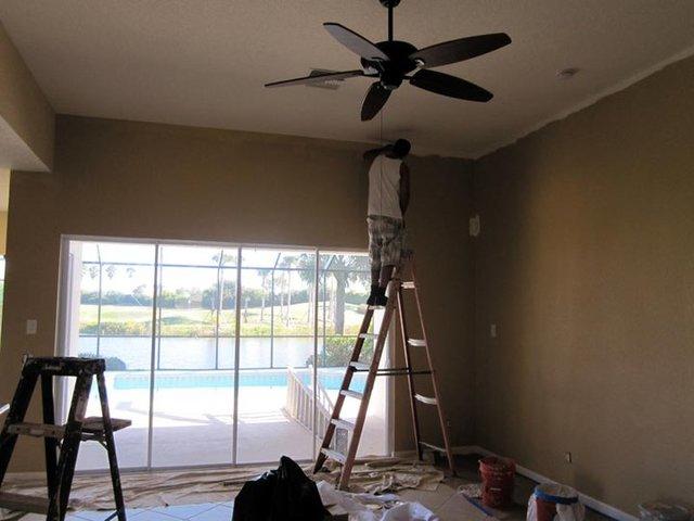 <p>This picture is showing a Scholar painter taking their time to make sure the edge of the wall color is perfect against the ceiling of the room.</p>