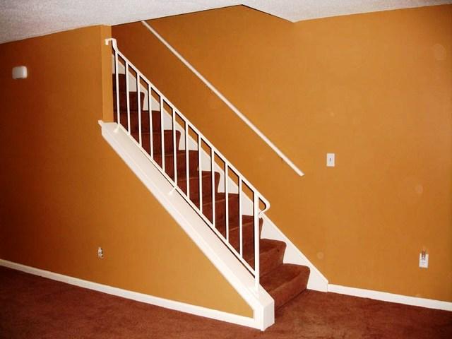 <p>The living room paint continues up to the second floor through the stairwell.</p>