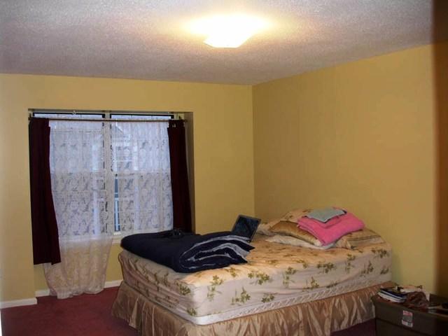 <p>This bedroom was painted yellow. The color really brightens up the room and complements the carpet.</p>