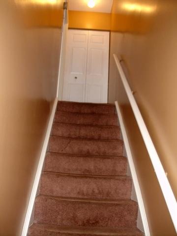 <p>This is another view of the freshly painted stairwell looking up towards the second floor.</p>