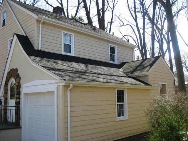 Stucco and wood shingles home, side view