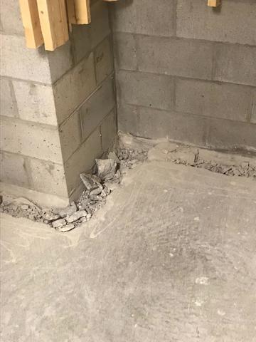 You can see that the installation crew has already started the first step of the WaterGuard installation --chipped away the concrete floor around the perimeter of the basement.