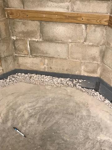 In this photo, you can see the Waterguard drainage system has been placed into the excavated trench around this Evansville, IN home.  The system will be covered with cement to make it practically invisible and easy to finish over with flooring!