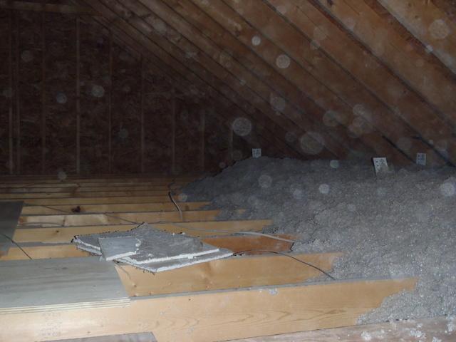 <p>This is a photo in the beginning parts of installation. This photo depicts how much insulation this attic should have. Looking at the insulation rulers sticking out of the top of the cellulose pile you can see that we didn't just meet the R38 but met the R60 measurement giving this home optimal resistance.</p>