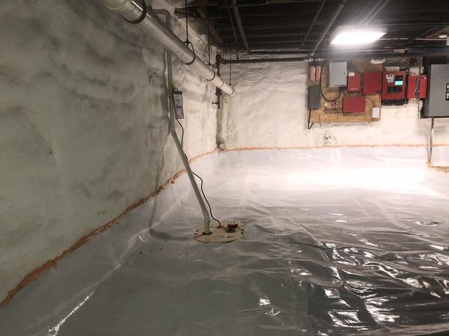 The experts have installed the Super Sump Pump and covered the floor with Clean Space.  They seal up the Clean Space with a polyurethane fire rated spray foam.