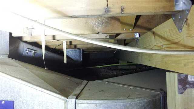 In addition to the already low clearance, HVAC ducts and pipes created a maze in this crawl space.