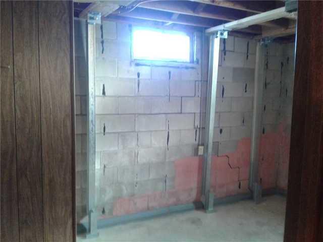 Our patented zinc coated steel I Beams are installed to support the shifted foundation wall.