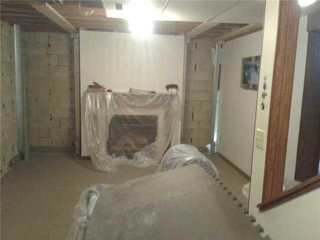 This part of the basement was finished and some preparations needed to be done to properly stabilize the foundation wall behind the previously finished wall