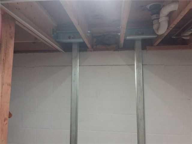 Here you can see where the PowerBrace is attached to the floor joists to help secure and straighten the wall.