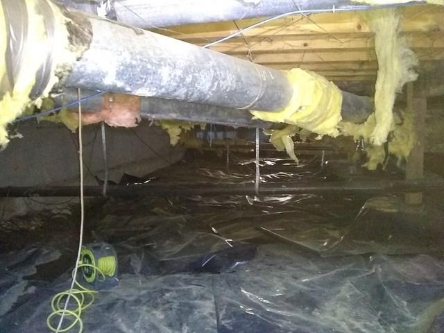 This crawlspace needs the ducts wrapped and the plastic fixed and water issues need to be fixed!