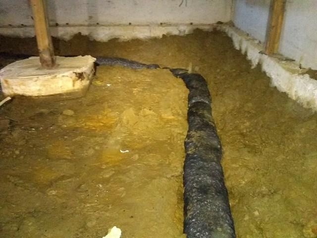 Our EZ Flo drainage pipe going in the crawlspace