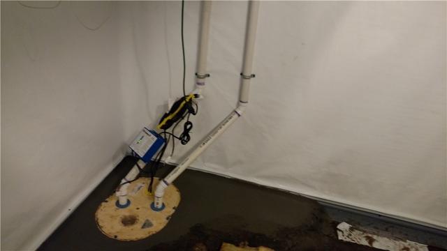 Newly installed sump pump system called the TripleSafe.  A sump pump is a neccessary element of a basement waterproofing system.