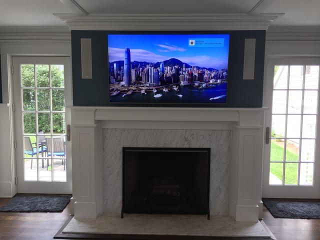 TV is mounted over the fireplace.