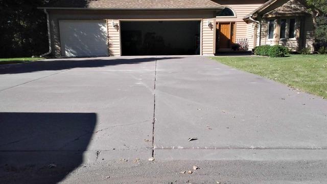 After the PolyLEVEL injection, the driveway is now a level surface. The Burgins will no longer have to worry about those concrete slabs sinking again.