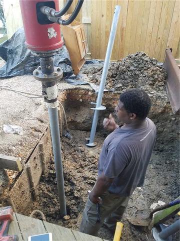 <p>Derrick keeps a watchful eye on the depth of this helical pier.</p>