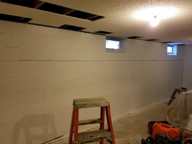 Before basement wall repair system with finished ceiling