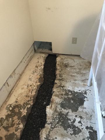 This hole is so the DryTrak can run seamlessly around the perimeter of the basement and catch any water that may come through the foundation and direct it to the sump system